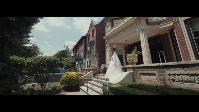 Bride outside a townhouse in a featured wedding film