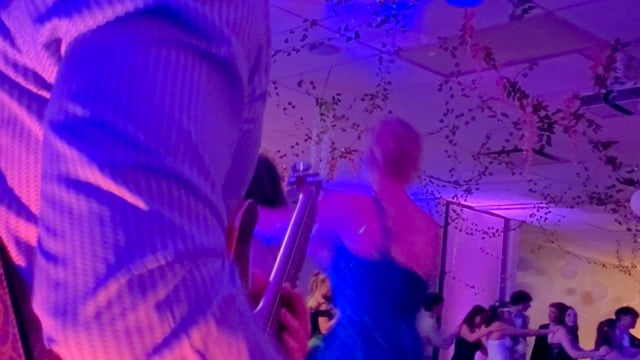 Kenny Kidd performing guitar with DJ and band at prom