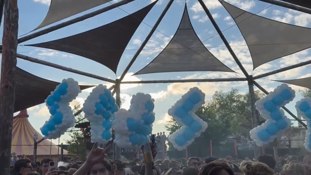 Spellbound balloon letters spelling STUSSY floating above the crowd at Thuishaven