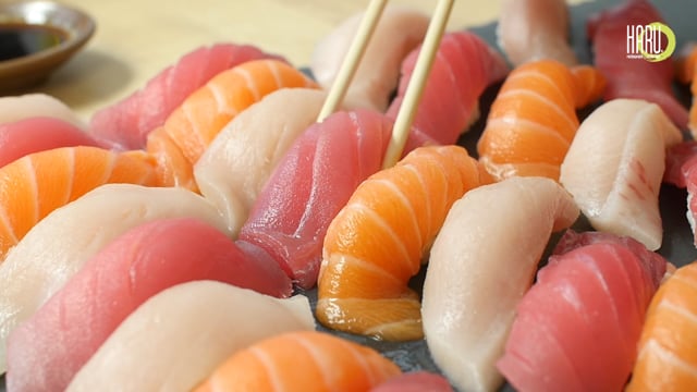 Nigiri sushi preparation in slow motion, showcasing precision culinary art and high-fidelity video production