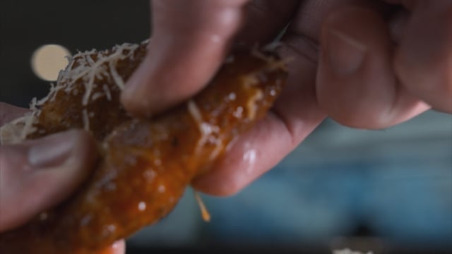 Expertly styled macro cheese pull, highlighting texture and appetite appeal in commercial food cinematography